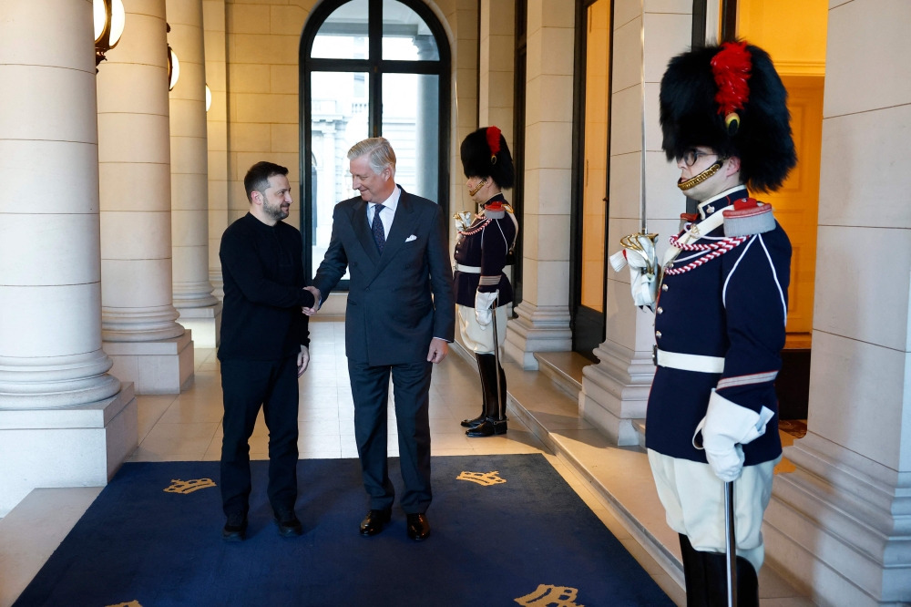 King Philippe of Belgium greets Ukraine's President Volodymyr Zelensky at the Royal Palace, on the sidelines of the Special European Council, in Brussels on March 6, 2025. (Photo by Stephanie Lecocq / POOL / AFP)