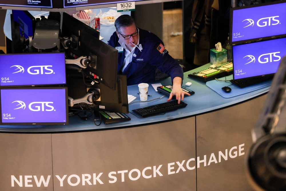 Traders work on the floor of the New York Stock Exchange (NYSE) at the opening bell on March 7, 2025, in New York City. (Photo by Charly Triballeau / AFP)
