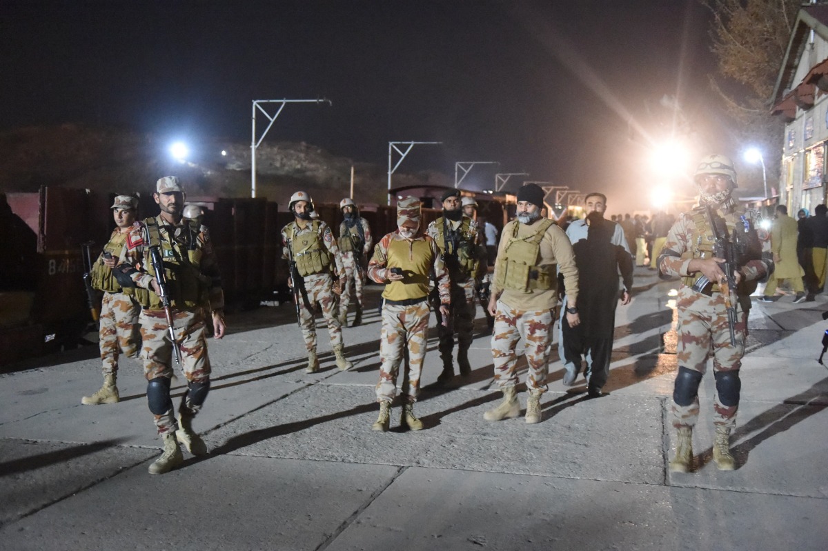 Soldiers secure Mach railway station after Pakistani security forces freed some passengers following a security operation against armed militants who ambushed the train in the remote mountainous area, in Mach, southwestern Balochistan province on March 12, 2025. (Photo by Banaras KHAN / AFP)
