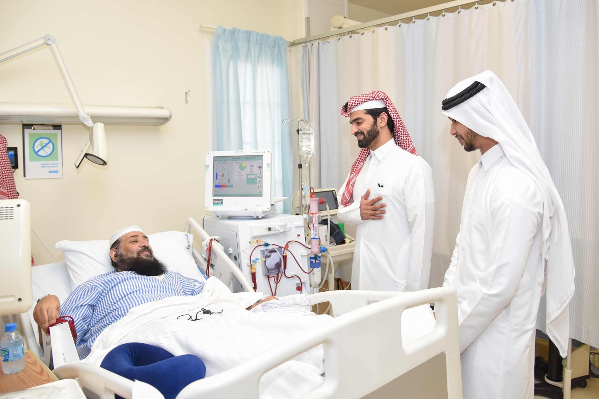 QNB officials interacting with a patient at Fahad Bin Jassim Kidney Centre. 