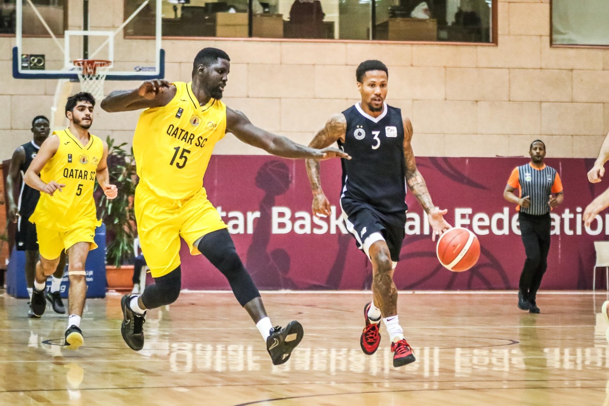 Al Sadd's J’von Joseph Mc Cormick (right) dribbles to the basket.