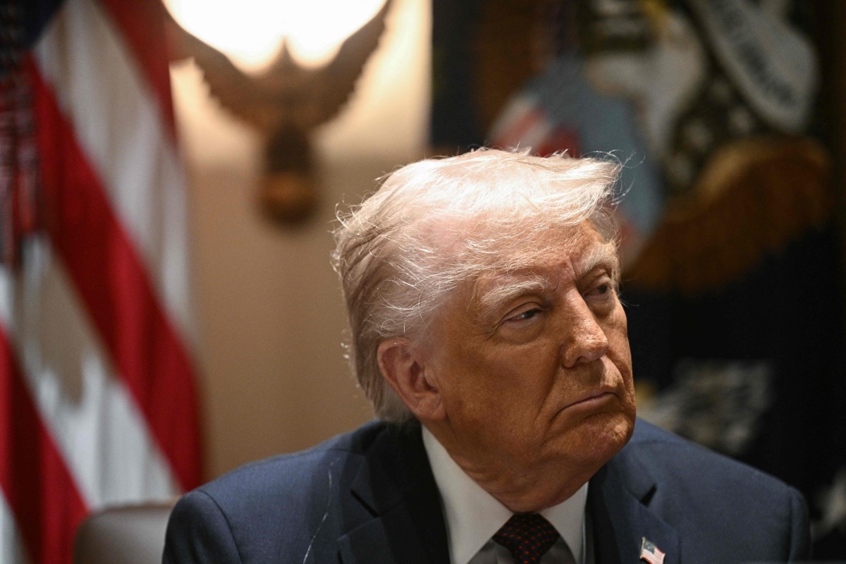 US President Donald Trump looks on during a cabinet meeting in the Cabinet Room of the White House on March 24, 2025, in Washington, DC. (Photo by Brendan SMIALOWSKI / AFP)