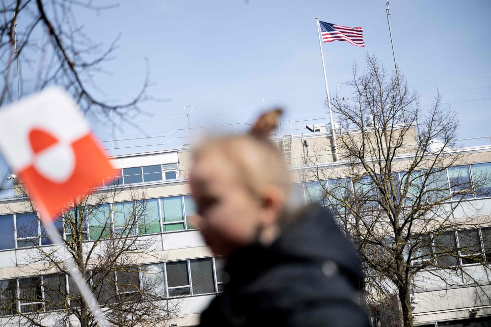 People protest against the American pressure taking place against Greenland and Denmark, in front of the American Embassy in Copenhagen on March 29, 2025. (Photo by Nils Meilvang / Ritzau Scanpix / AFP) 