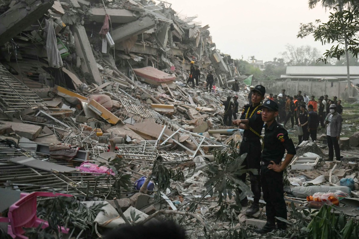Rescuers search for survivors trapped in the collapsed Sky Villa Condominium building in Mandalay on March 29, 2025, a day after an earthquake struck central Myanmar. Rescuers pulled a woman alive from the wreckage of a collapsed apartment building in Mandalay on March 29, AFP journalists saw, 30 hours after a devastating quake hit Myanmar. (Photo by Sai Aung MAIN / AFP)
