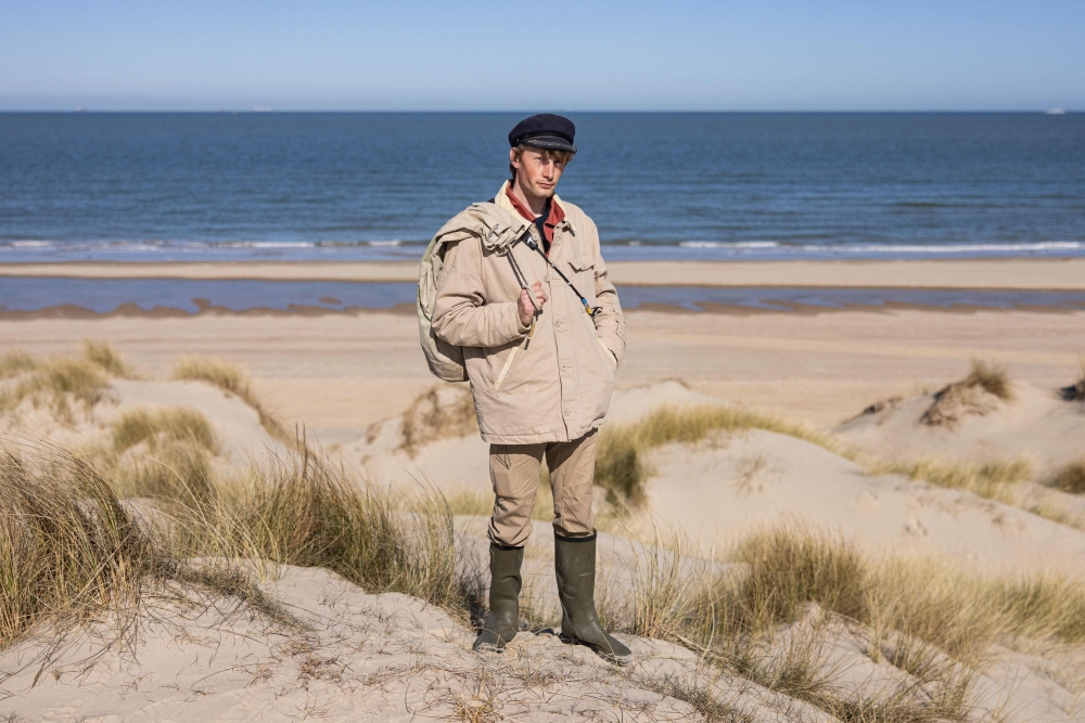 Aaron Fabrice de Kisangani poses for a picture near the beach of Calais, north of France on March 26, 2025. (Photo by Sameer Al-DOUMY / AFP)