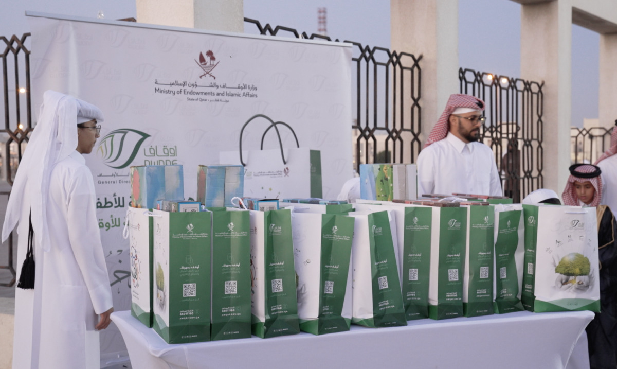 Officials distributing gifts at a prayer ground.
