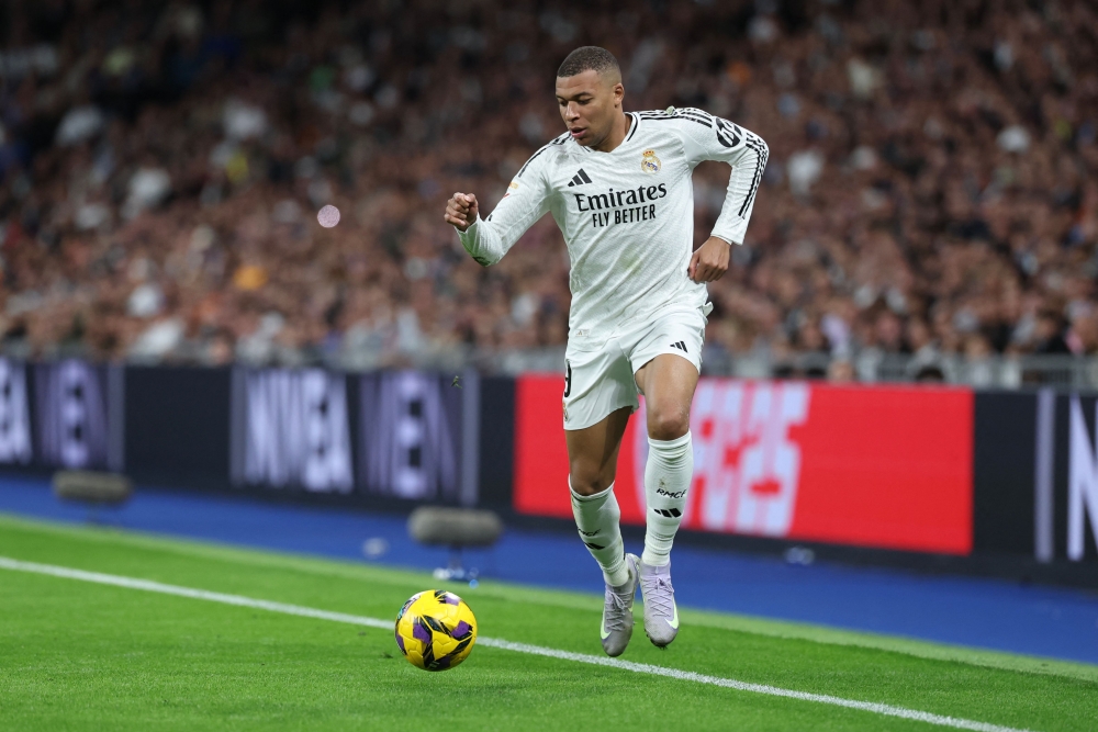 Real Madrid's French forward #09 Kylian Mbappe runs with the ball at the Santiago Bernabeu stadium in Madrid on March 29, 2025. (Photo by Thomas Coex / AFP)