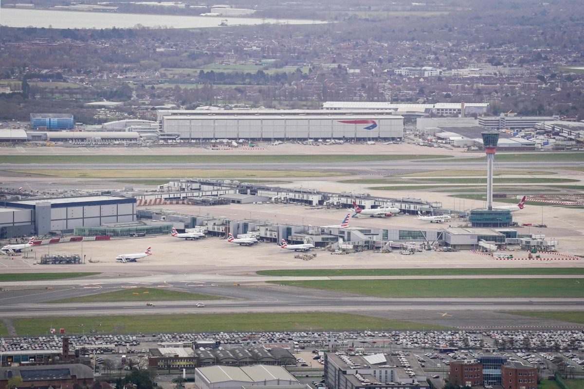 An aerial photograph taken on March 21, 2025 shows planes parked on the tarmac of Heathrow Airport following its closure after a fire broke out at a substation supplying power of the airport, in Hayes, west London. Photo by AFP