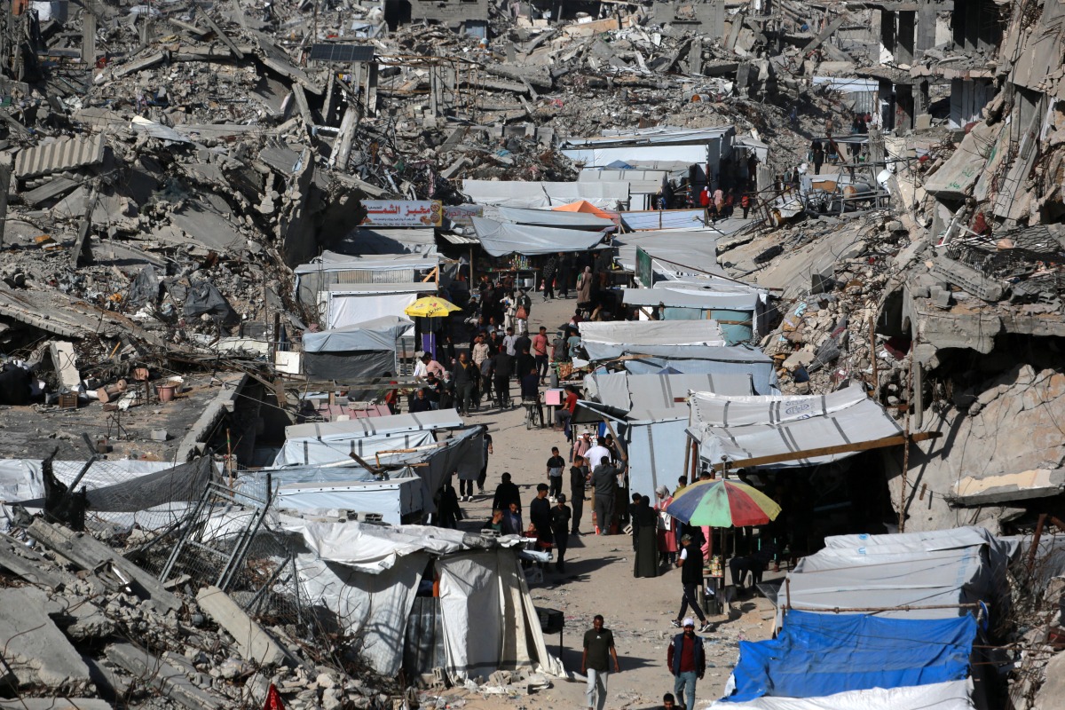 This aerial view shows Palestinians gathered at a makeshift market set up in the midst of a war devastated neighbourhood in the Jabalia refugee camp in the northern Gaza Strip on April 2, 2025. Photo by Bashar TALEB / AFP
