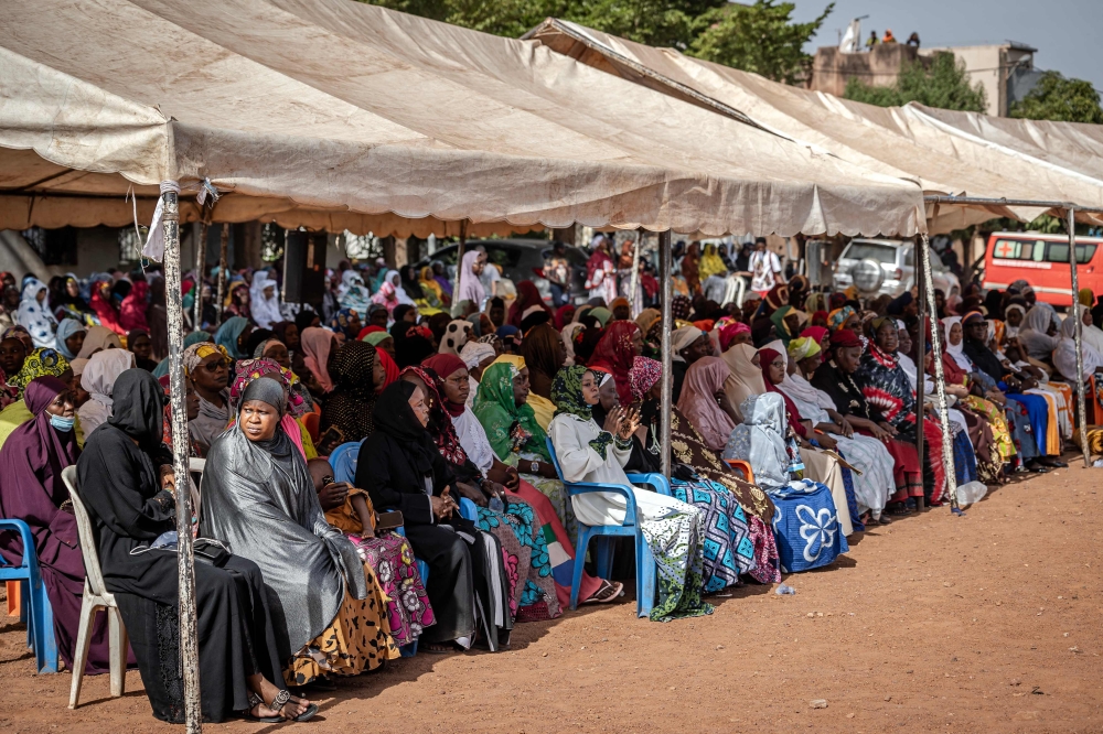 Women gather to pay their respects at the funeral ceremony of guitarist and singer Amadou Bagayoko in Bamako on April 6, 2025. (Photo by Ousmane Makaveli / AFP)

