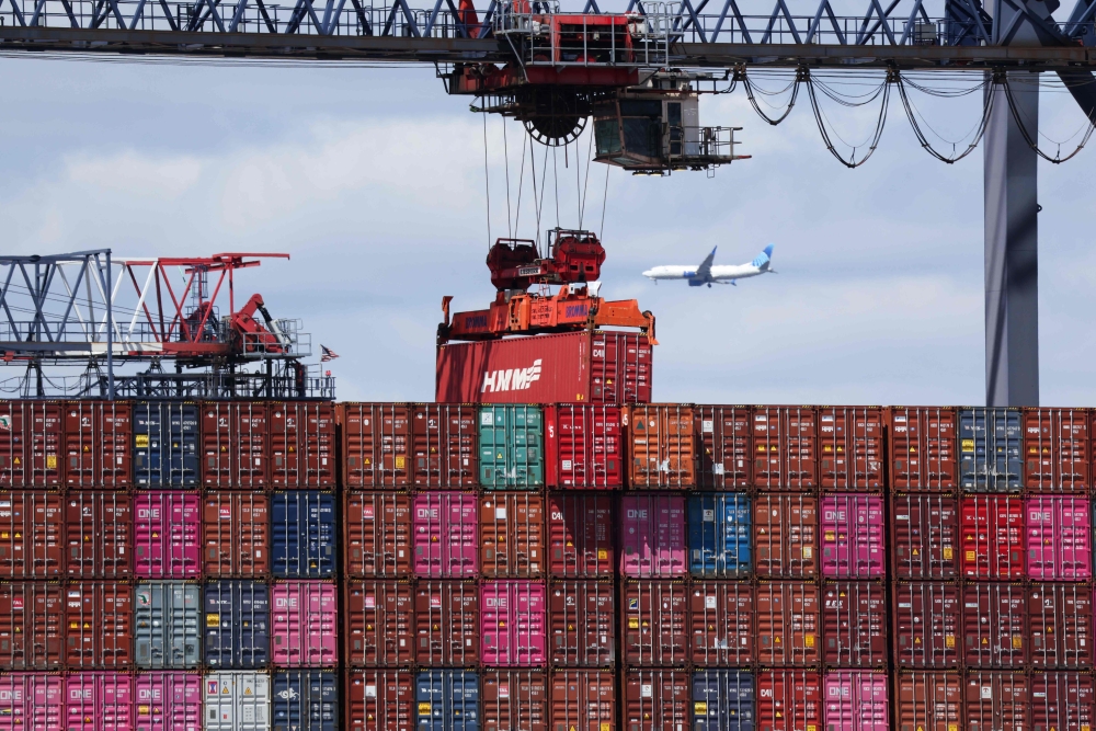 A shipping container is moved at the Port Jersey Container Terminal in Jersey City, New Jersey on April 8, 2025. (Photo by Charly Triballeau / AFP)
