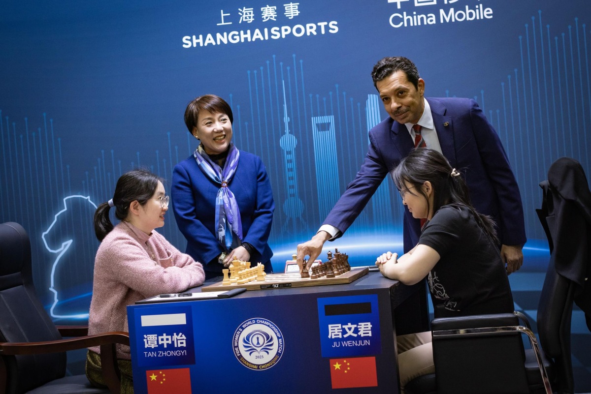 QCA President Mohammed Al Mudahka makes the opening move for match between China's Ju Wenjun and Tan Zhongyi.  
