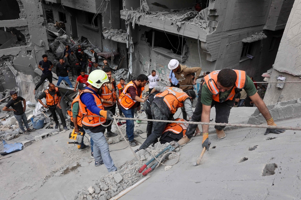 Palestinian rescuers work at the site of an Israeli strike on a residential area in Gaza City's Shujaiyya neighbourhood, on April 9, 2025. (Photo by Omar Al-Qattaa / AFP)