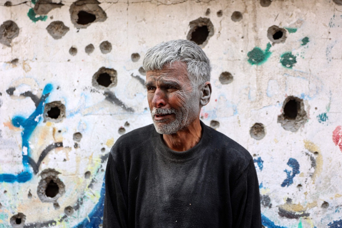 An elderly Palestinian man reactsas he stands in front of a building hit by an Israeli strike, in Gaza City's eastern neighbourhood of Shujaiya on April 10, 2025. Photo by Omar AL-QATTAA / AFP