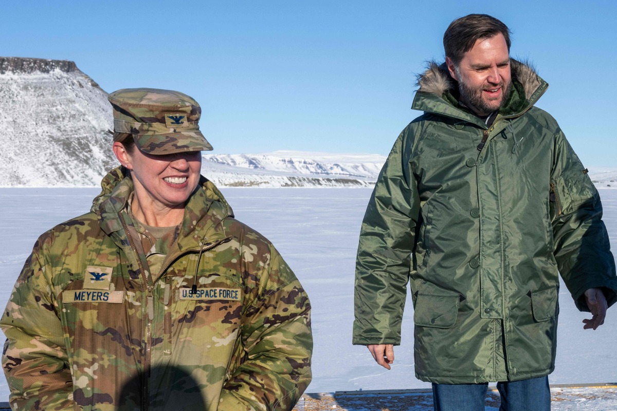 US Vice President JD Vance walks with Col. Susan Meyers (L), commander of the US military's Pituffik Space Base, as they tour the base in Greenland on March 28, 2025. (Photo by Jim WATSON / POOL / AFP)
