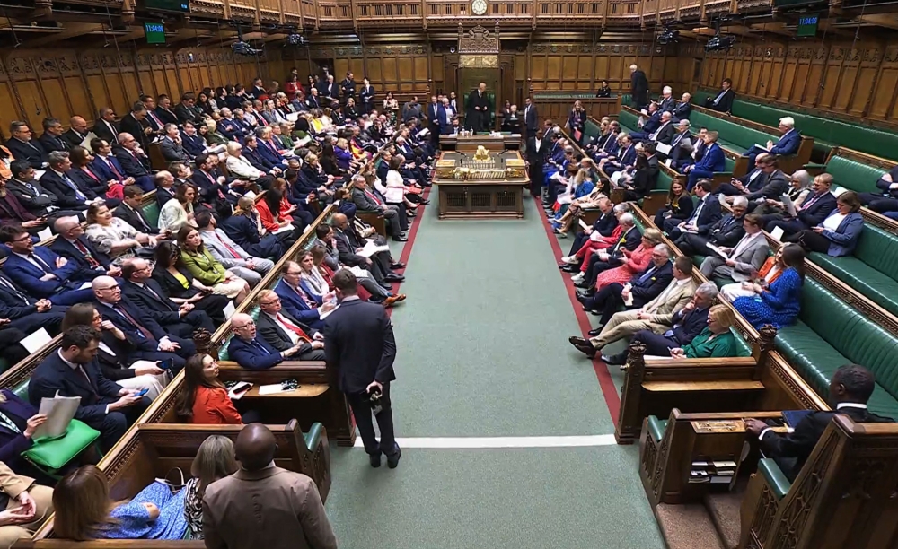 In this video grab taken from footage broadcast by the UK Parliamentary Recording Unit (PRU) via the Parliament TV website on April 12, 2025, members of parliament in the House of Commons take their seats at the start of a debate on emergency legislation to take special measures to protect the British Steel Industry. (Photo by PRU / AFP) 