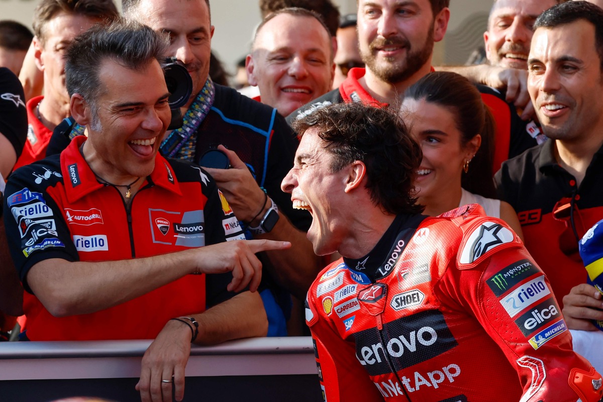Pole position winner, Ducati Lenovo's Spanish rider Marc Marquez, celebrates with his team following the qualifying session for the Qatar Moto GP Grand Prix at the Lusail International Circuit on April 12, 2025. (Photo by Karim JAAFAR / AFP)

