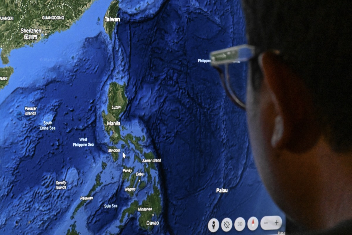 This photo illustration shows a man looking at a map on a computer screen in Manila on April 14, 2025. Photo by Jamillah STA. ROSA / AFP