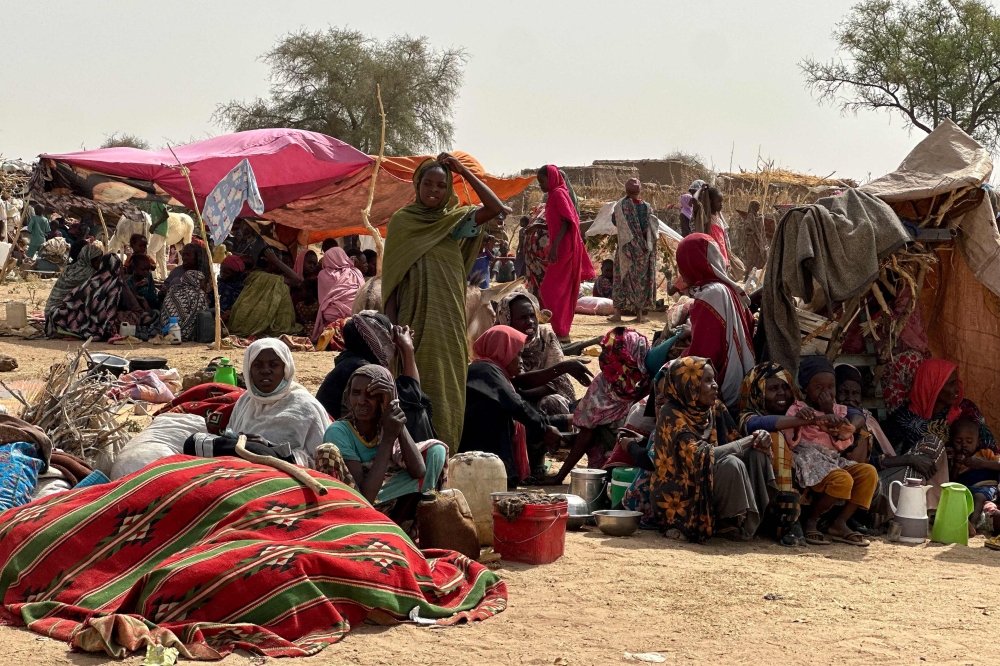 People who fled the Zamzam camp for the internally displaced after it fell under RSF control, rest in a makeshift encampment in an open field near the town of Tawila in war-torn Sudan's western Darfur region on April 13, 2025. (Photo by AFP)
