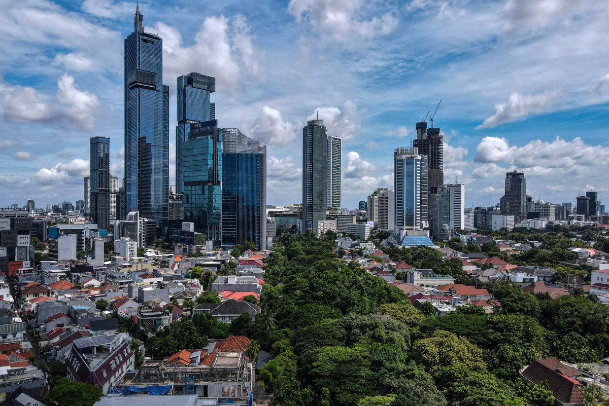 This aerial picture shows skyscrapers in Jakarta's business district on April 14, 2025. (Photo by BAY ISMOYO / AFP)
