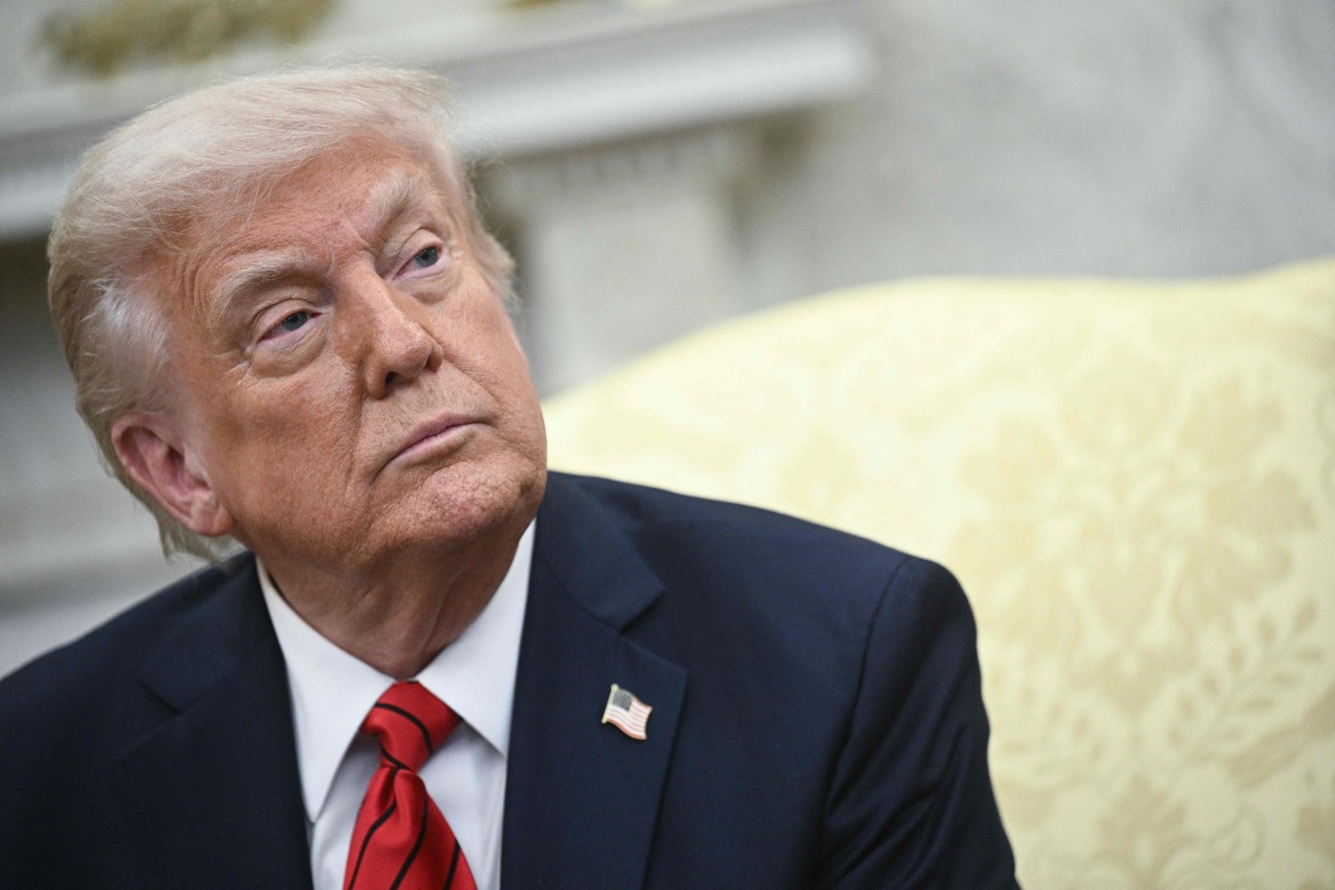 US President Donald Trump listens as he meets with Italian Prime Minister Giorgia Meloni in the Oval Office of the White House in Washington, DC, on April 17, 2025. (Photo by Brendan SMIALOWSKI / AFP)
