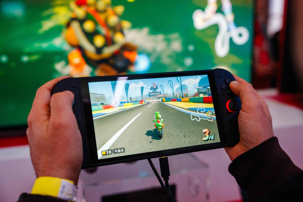 File: A guest plays Mariokart World with the new Nintendo Switch 2 video-game console system of Japanese video-game company Nintendo during the worldwide presentation at the Grand Palais in Paris on April 2, 2025. (Photo by Dimitar Dilkoff / AFP)