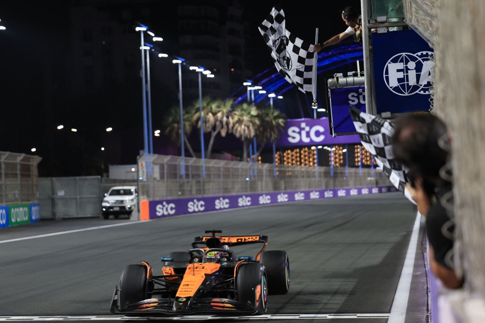 McLaren's Australian driver Oscar Piastri crosses the finish line to win the 2025 Saudi Arabia Formula One Grand Prix at the Jeddah Corniche Circuit on April 20, 2025. (Photo by Thaier Al Sudani / POOL / AFP)