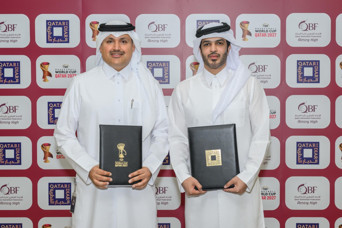 QBF President Mohammed Saad Al-Mughaiseeb and Chief Development and Asset Management Officer of Qatari Diar Fahad Abdullatif Al Jahrami pose for a picture after the signing ceremony.
