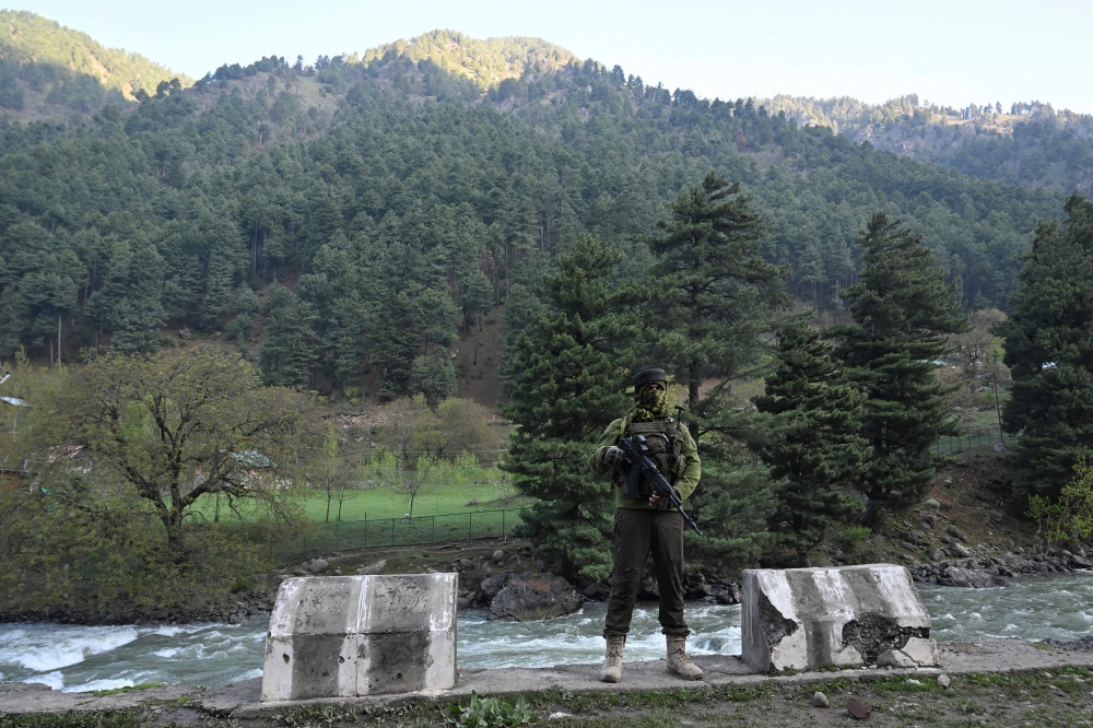 An Indian paramilitary serviceman keeps watch in Pahalgam, south of Srinagar on April 23, 2025, following an attack. (Photo by Tauseef Mustafa / AFP)