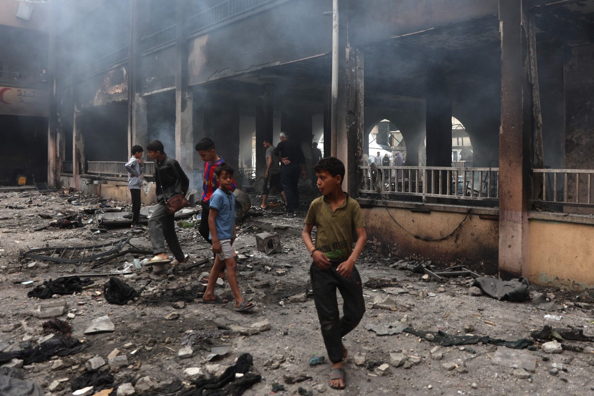 Palestinians inspect the damage after an Israeli strike on a school housing displaced Palestinians in Gaza City on April 23, 2025. (Photo by Omar AL-QATTAA / AFP)
