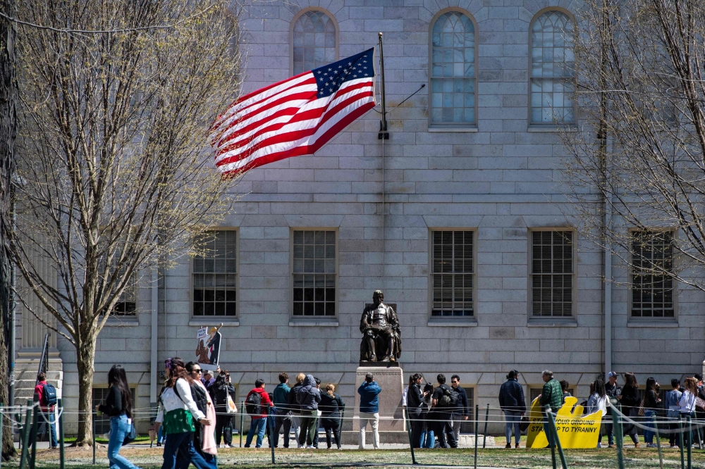 Demonstrators stand around the John Harvard Statue in Harvard Yard following a rally against President Donald Trump痴 attacks on Harvard University at Harvard University in Cambridge, Massachusetts on April 17, 2025. (Photo by Joseph Prezioso / AFP)