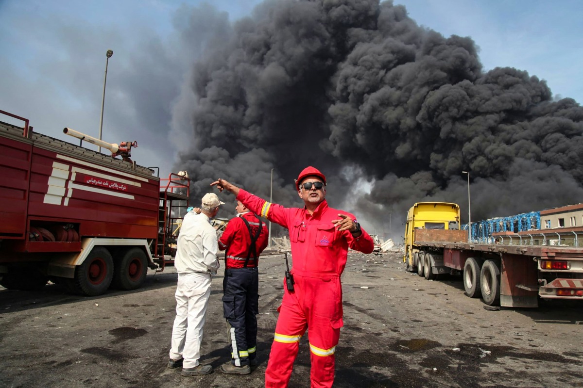 Thick, black smoke rises as rescuers arrive near the source of an explosion at the Shahid Rajaee port dock southwest of Bandar Abbas in the Iranian province of Hormozgan on April 26, 2025. (Photo by MOHAMMAD RASOLE MORADI / IRNA / AFP)
