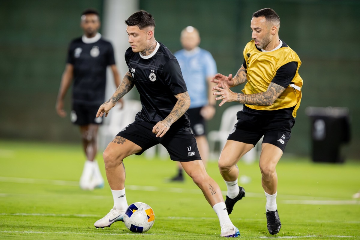 Al Sadd's Cristo Gonzalez (left) and Guilherme Torres during a training session yesterday.