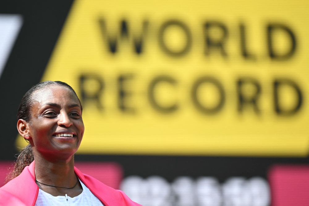 Ethiopia's Tigst Assefa smiles after crossing the line to win the women's race at the 2025 London Marathon in central London on April 27, 2025. (Photo by Justin Tallis / AFP) / 