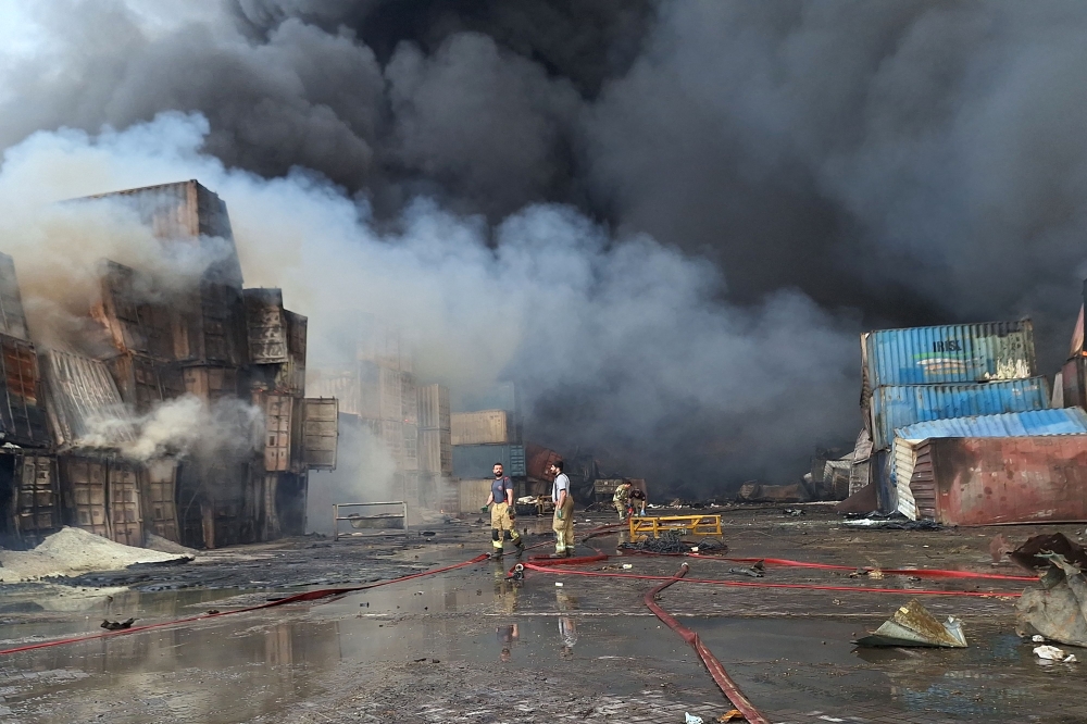 Firefighters and rescuers work at the scene of an explosion that took place a day earlier at the Shahid Rajaee port dock, southwest of Bandar Abbas in the Iranian province of Hormozgan, on April 27, 2025.  (Photo by Meysam Mirsadeh / Tasnim News / AFP)