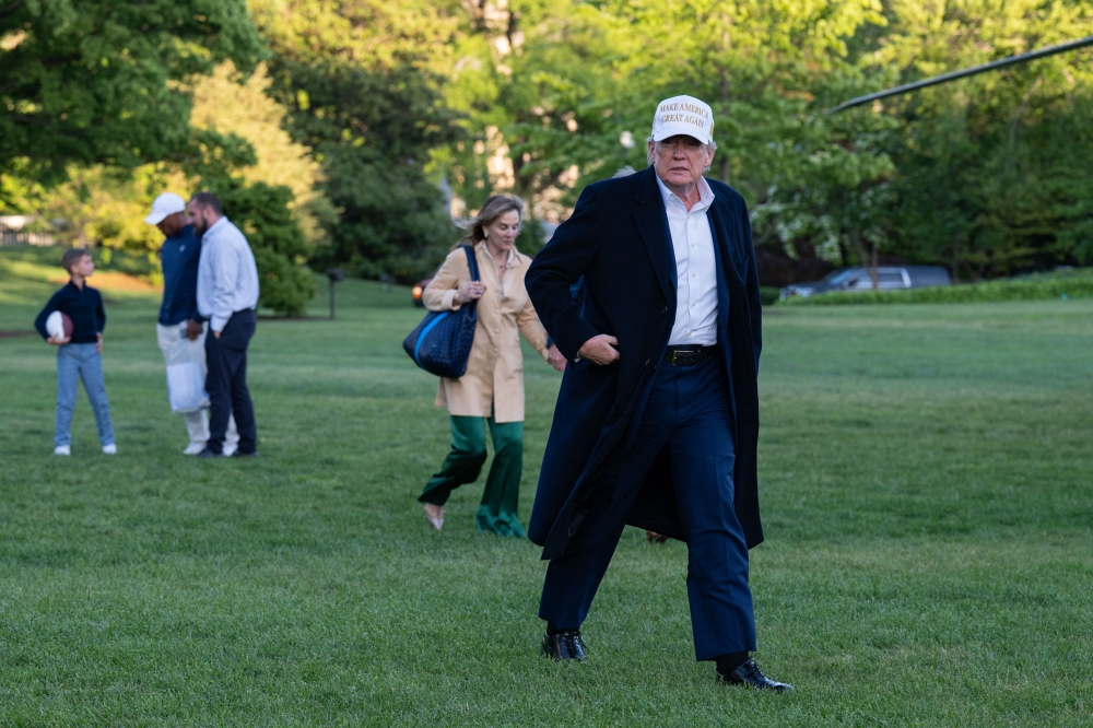 US President Donald Trump walks toward the press after arriving on the South Lawn of the White House in Washington, DC, on April 27, 2025. (Photo by Annabelle Gordon / AFP)
