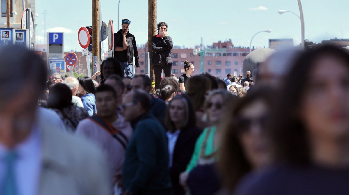 People wait outside the Atocha train station in Madrid after its closure as a massive power outage hits Spain on April 28, 2025. Photo by Thomas COEX / AFP