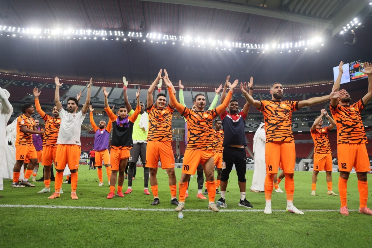 Umm Salal players celebrate their victory.