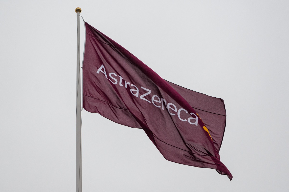A flag with the logo of pharmaceutical company AstraZeneca flies outside their facility for biological medicines in Södertälje, south of Stockholm, Sweden on February 8, 2022. Photo by Jonathan NACKSTRAND / AFP.
