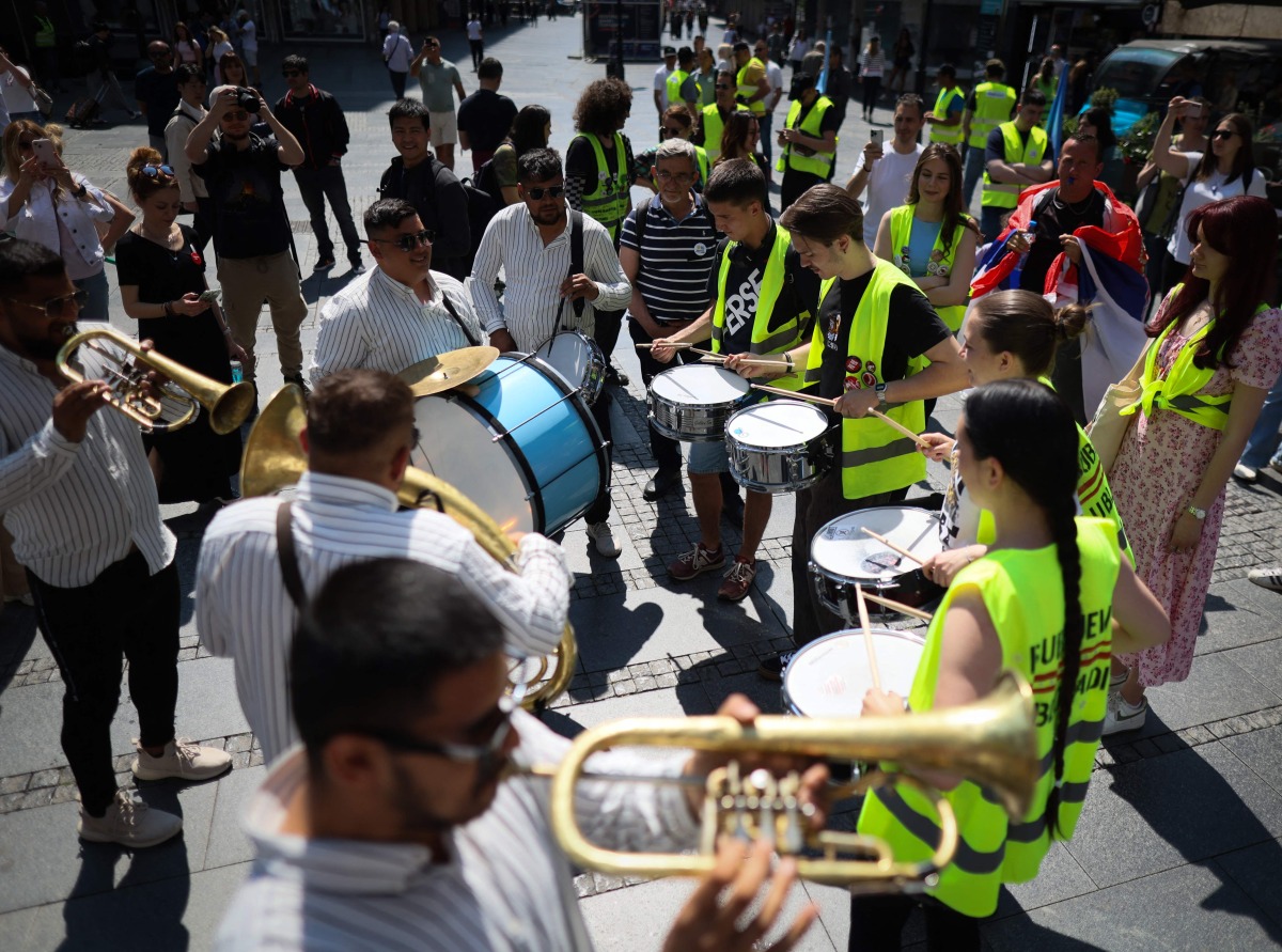 Students and street musicians perform during a May Day (Labour Day) rally, marking International Workers' Day, in Belgrade, on May 1, 2025. (Photo by OLIVER BUNIC / AFP)