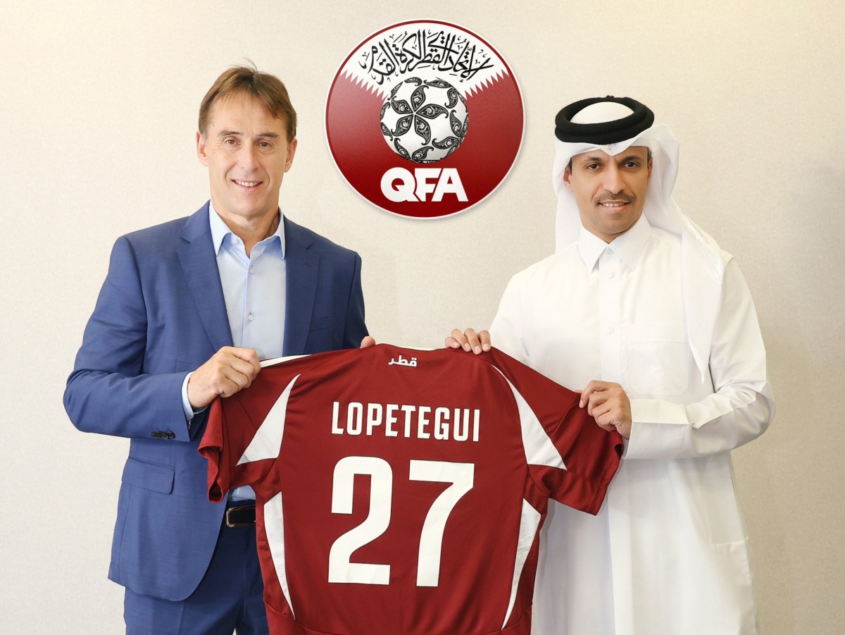 Newly appointed Qatar head coach Julen Lopetegui receives his jersey from QFA President Jassim bin Rashid Al-Buainain. 