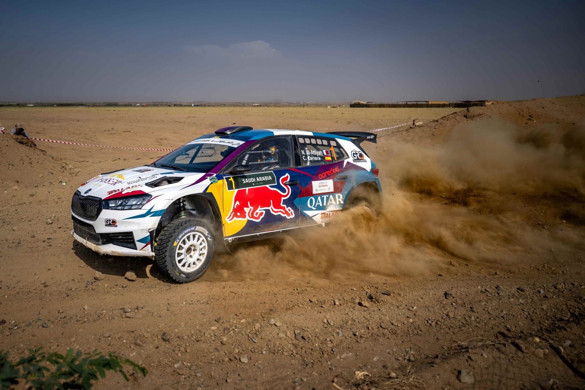 Qatar's Nasser Saleh Al Attiyah and his Spanish co-driver Candido Carrera celebrate after the win.