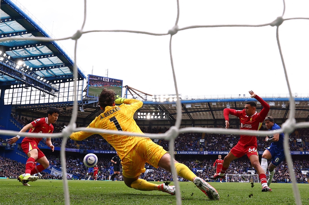 Chelsea's Argentinian midfielder #08 Enzo Fernandez (right) scores the opening goal during the English Premier League football match between Chelsea and Liverpool at Stamford Bridge in London on May 4, 2025. (Photo by Henry Nicholls / AFP)