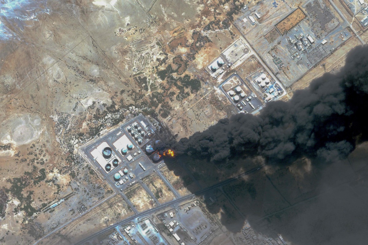 This handout satellite photo obtained from Planet Labs PBC and dated May 6, 2025, shows smoke billowing from a fuel storage depot after a strike on Port Sudan. (Photo by Planet Labs PBC / AFP)