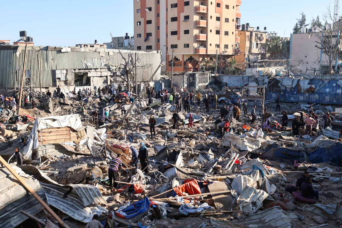 Palestinians sift through destroyed shelters at a UNRWA school housing displaced people, following an Israeli strike in the Bureij refugee camp in the centre of the Gaza Strip, on May 7, 2025. Photo by Eyad BABA / AFP