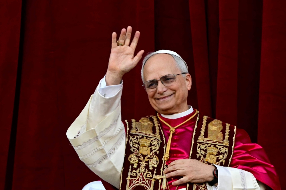 Newly elected Pope Leo XIV, Robert Prevost addresses the crowd from the main central loggia balcony of the St Peter's Basilica for the first time, after the cardinals ended the conclave, in The Vatican, on May 8, 2025. (Photo by Tiziana Fabi / AFP)