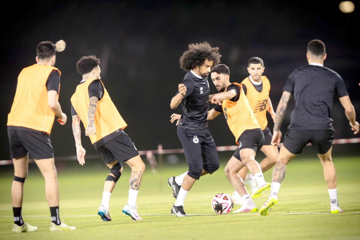 Al Sadd's Akram Afif (centre) trains with teammates.