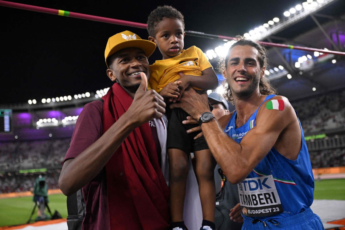 A file photo of Gianmarco Tamberi (right) and Mutaz Barshim and his son. 