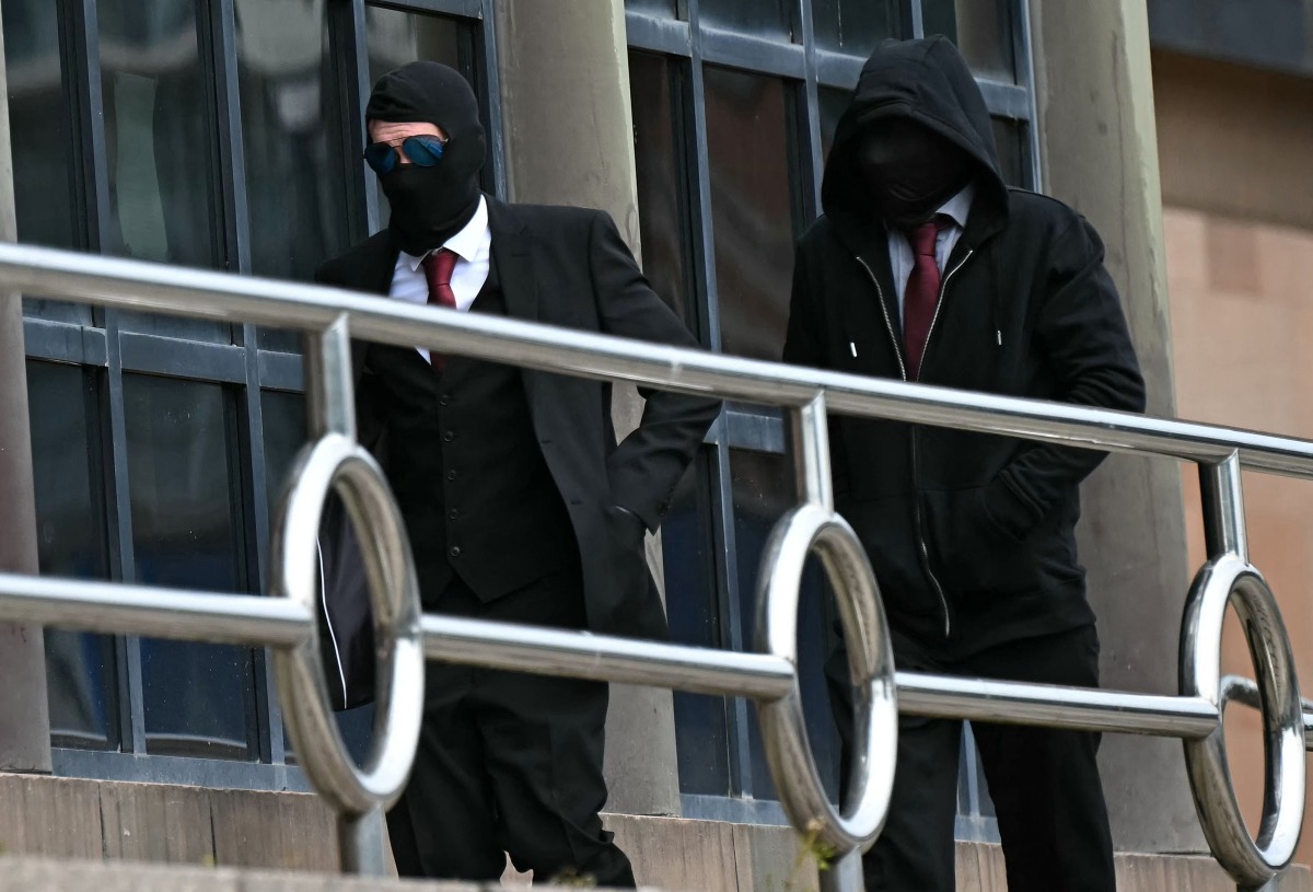  Daniel Graham (L), and Adam Carruthers, wearing face-coverings, arrive at Newcastle Magistrates' Court in Newcastle-Upon-Tyne, north east England on May 15, 2024, where they face two counts of criminal damage following the felling of the Sycamore Gap tree, in September 2023. Photo by Paul ELLIS / AFP