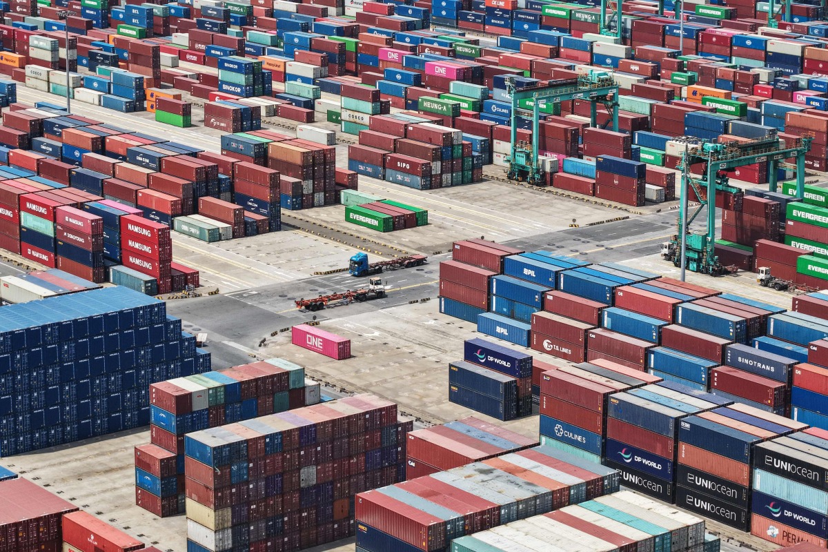 Shipping containers are stacked at a port in Shanghai on May 9, 2025. Photo by AFP